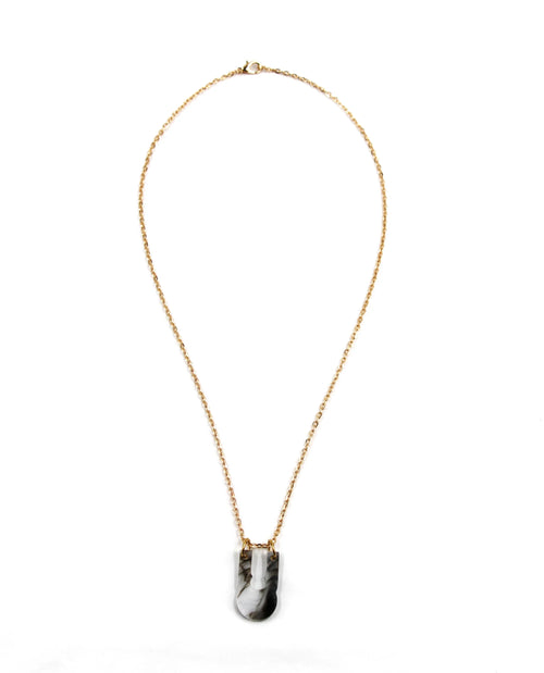 Colar dourado com pendente marmoreado em preto e branco